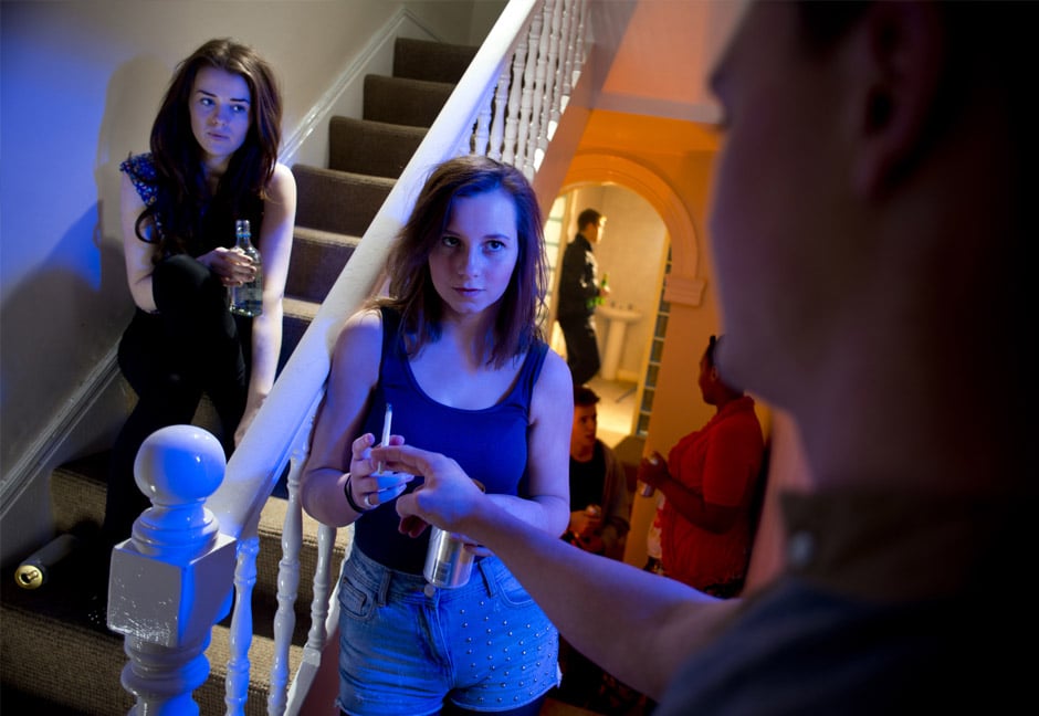 Two girls experiencing peer pressure to smoke